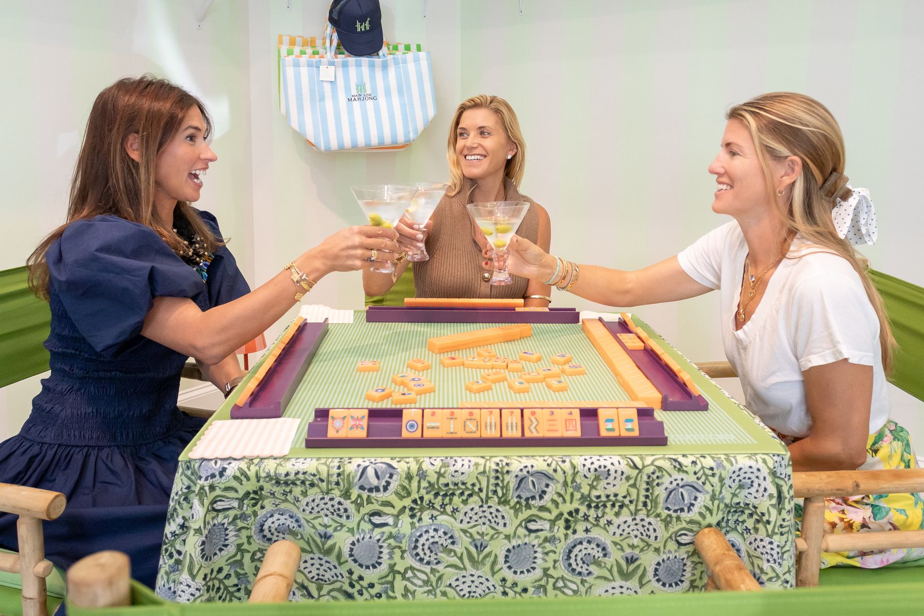 The Main Line Mahjong co-founders toasting over a game at the studio